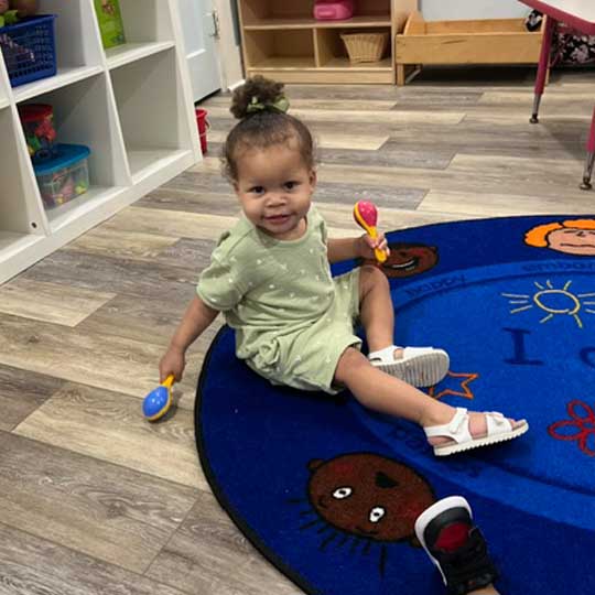 Small child playing on floor.